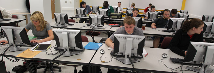 Students in a lab focus on getting homework done