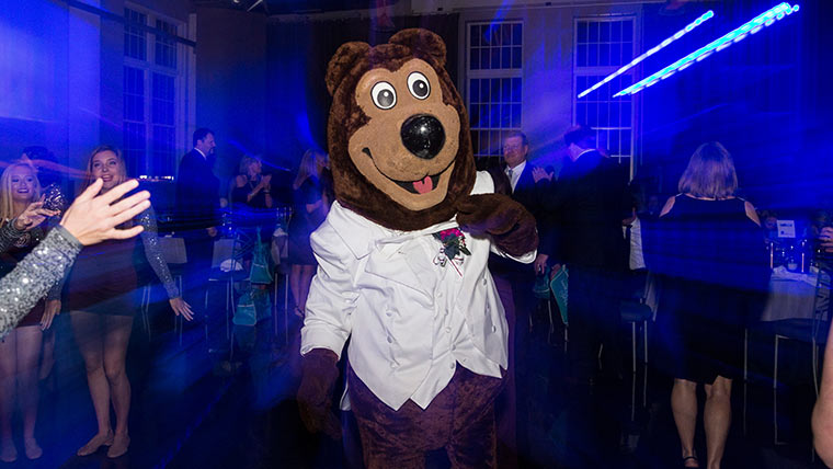 Boomer Bear having fun on the dance floor at an alumni event.