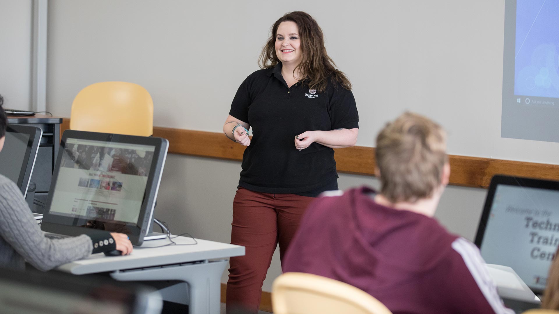 A computer services employee smiles as she conducts a training workshop in Cheek Hall.