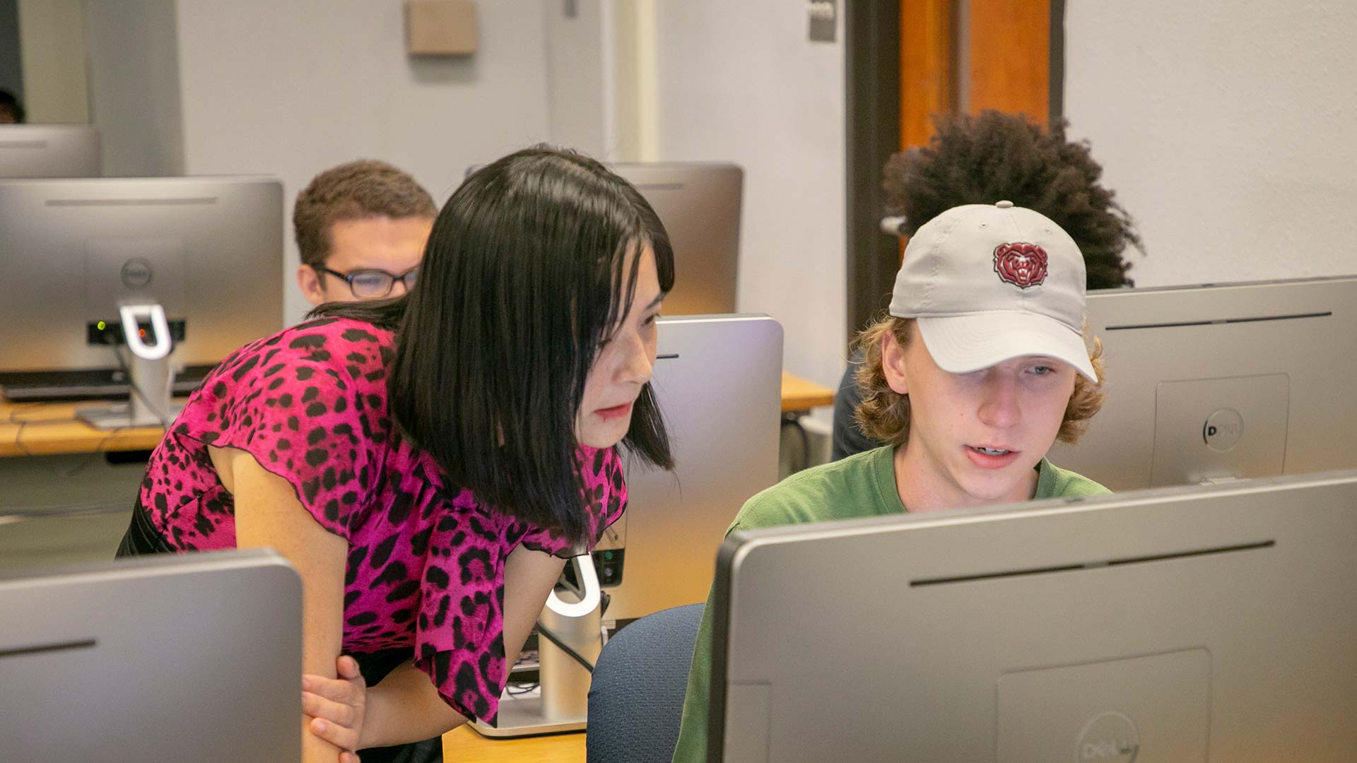 Dr. Hui Liu assists student Zack Mueller with his computer classwork in the CSC 232: Data Structures class.