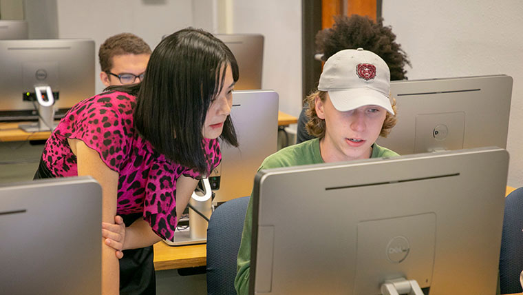Computer science professor Dr. Hui Liu helps a student during an undergraduate class.